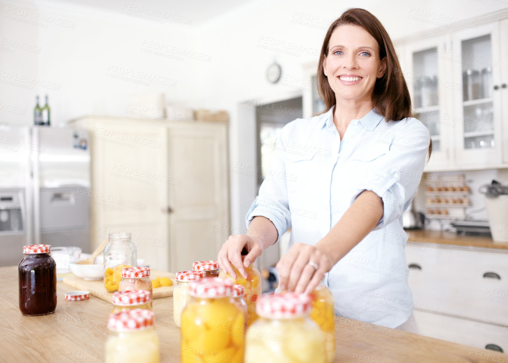 Buy stock photo Kitchen, fruit and woman with jars of peach, smile and portrait of nutritionist, healthy and house. Home, nutrition and person with hands on food, container and storage for nectarine in apartment