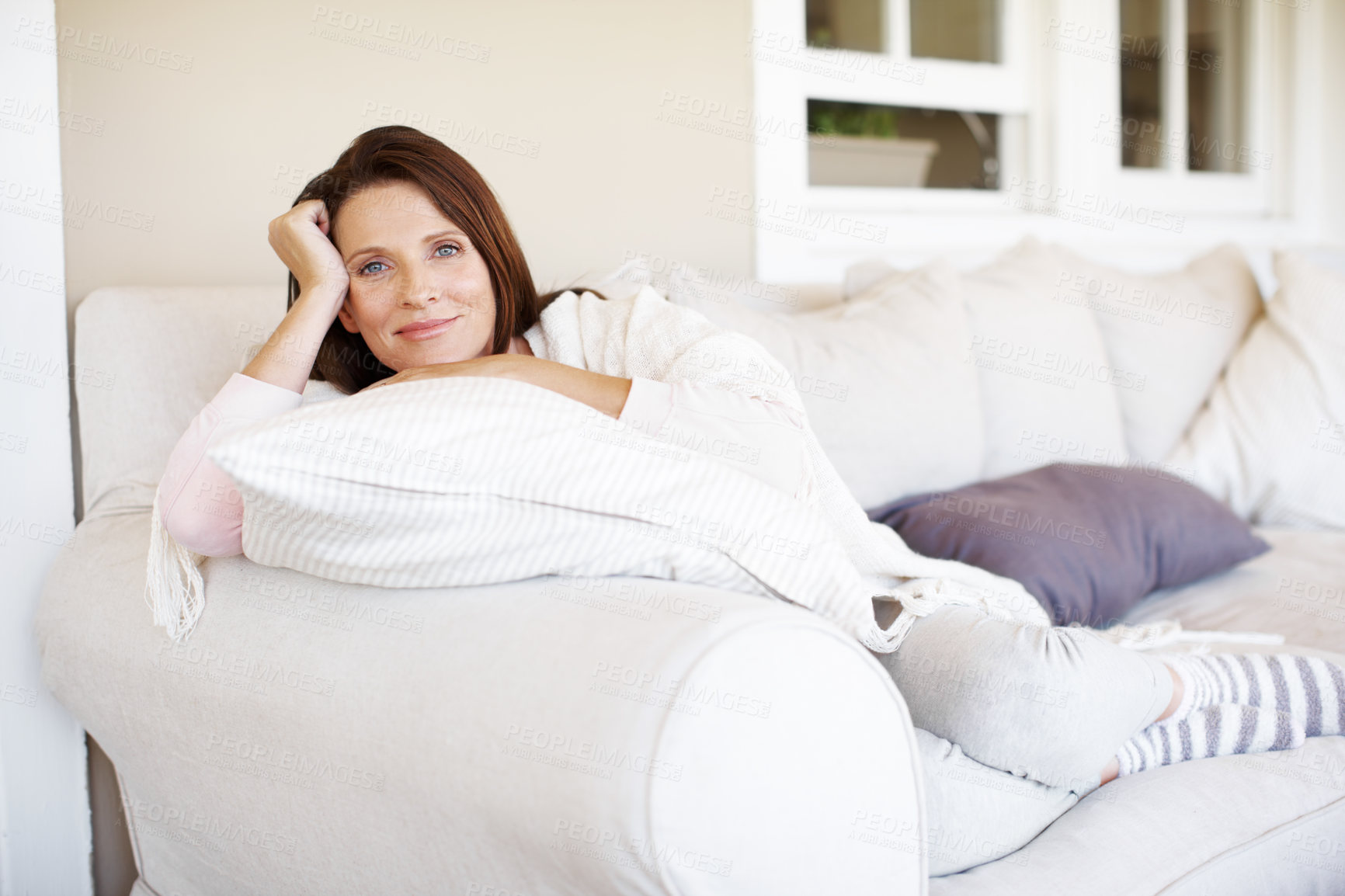 Buy stock photo Portrait of woman, relax and smile on couch for weekend, calm and break in living room. Happy, female person and confidence or carefree in home for holiday or vacation, self care and peace on sofa