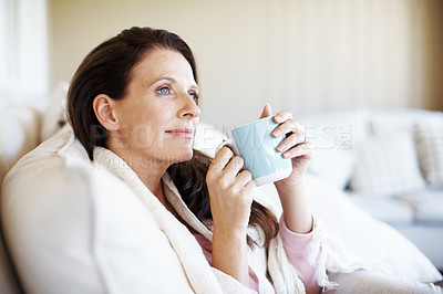 Buy stock photo Closeup shot of an attractive woman enjoying a cup of coffee and looking contemplative