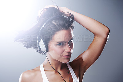 Buy stock photo Headphones, woman and portrait with dancing, music and radio in a studio. Smile, happy female person and audio for streaming and podcast with freedom and sound with confidence and grey background