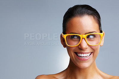 Buy stock photo Closeup portrait of a smiling young woman wearing glasses while looking at copyspace