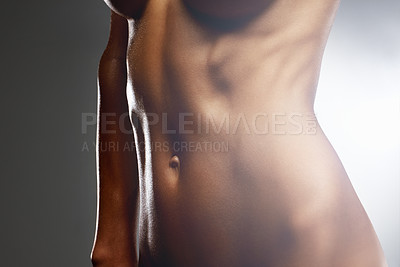 Buy stock photo Mid section of a naked woman isolated against colored background