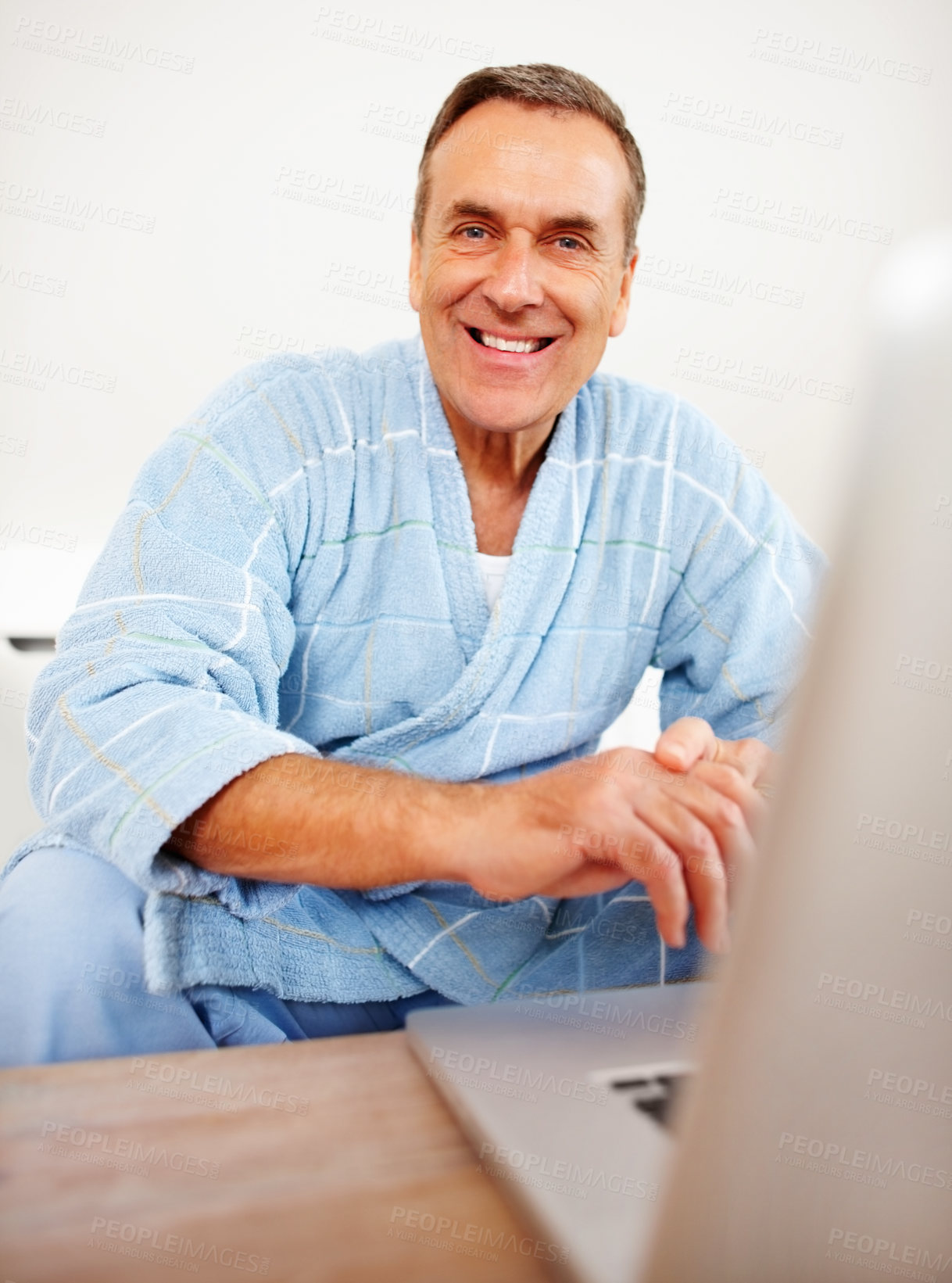 Buy stock photo Bathrobe, portrait and mature man on laptop for email, social media or streaming subscription on sofa. Internet search, couch and senior person on computer, website and networking with smile in home.