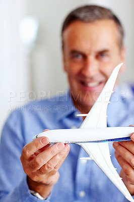 Buy stock photo Hands, travel and model airplane with a businessman in the office for a global or international trip. Corporate, transport or journey and a happy professional employee with a toy vehicle for flight