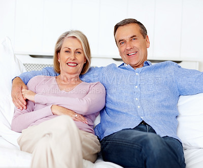 Buy stock photo Senior, couple and portrait or happy on sofa with support, relationship and marriage in retirement home. Elderly, man and woman with smile on couch in living room with trust, care and love in house 