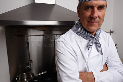 Buy stock photo Man, portrait and chef with arms crossed in kitchen for cooking, hospitality or culinary professional. Mature person, smile and confidence at hotel restaurant for dinner cuisine, menu or service