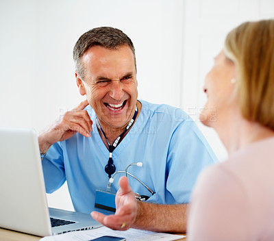 Buy stock photo Mature doctor, patient and consultation in clinic, man and laptop for diagnosis or treatment plan. Male person, laughing and advice in conversation or help, trust and physician for results of test