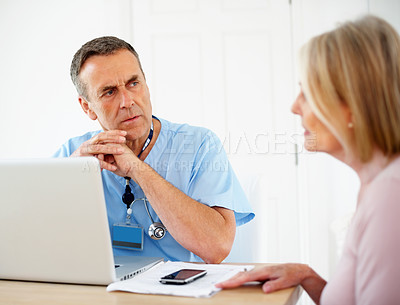 Buy stock photo Serious doctor, laptop and consultation with patient for healthcare problem, help and diagnosis in clinic. Gynecology expert, man and woman for menopause crisis, planning pap smear and advice