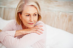 Relaxed mature woman in bed looking away