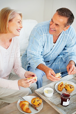 Buy stock photo Senior couple, bedroom and food for romance, breakfast and wellness for retirement health. Mature woman, man and croissant or muffin for meal with fruit jam for diet, nutrition and care for support