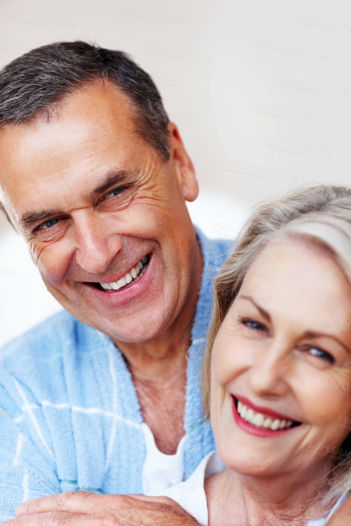 Buy stock photo Mature couple, hug and love in home with bonding for retirement, leisure and wellness in gown. Man, woman and portrait in house for peace, health and relax with smile, happiness and stress relief