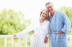 Mature couple in bathrobes enjoying their retirement vacation