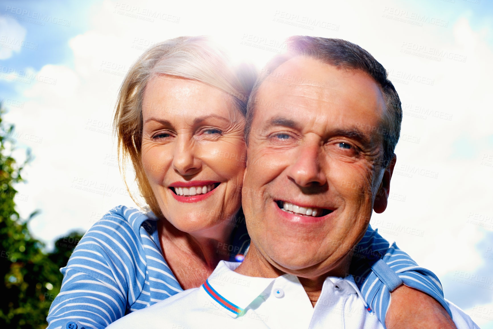 Buy stock photo Closeup portrait of a romantic senior couple having fun against sky