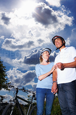 Buy stock photo Mature couple, helmet and bicycle in nature for hobby, portrait or smile on weekend for exercise. Fitness, cardio or bike with safety hands for workout and health, cycling or married people for sport