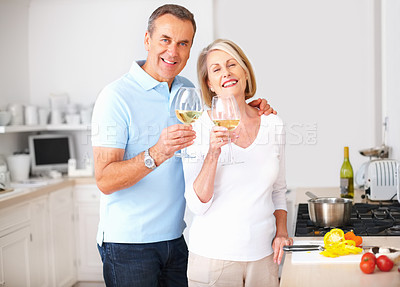 Buy stock photo Happy couple, mature and wine with toast at dinner, meal and nutrition as romantic partner. Senior people, cooking and kitchen with bonding, relationship and together in home for diet, health or love