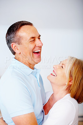 Buy stock photo Senior couple, happy and laughing in house for love, hug or anniversary as romantic partner. Mature, people and affection for bonding, relationship and together in home with embrace, loyalty or care