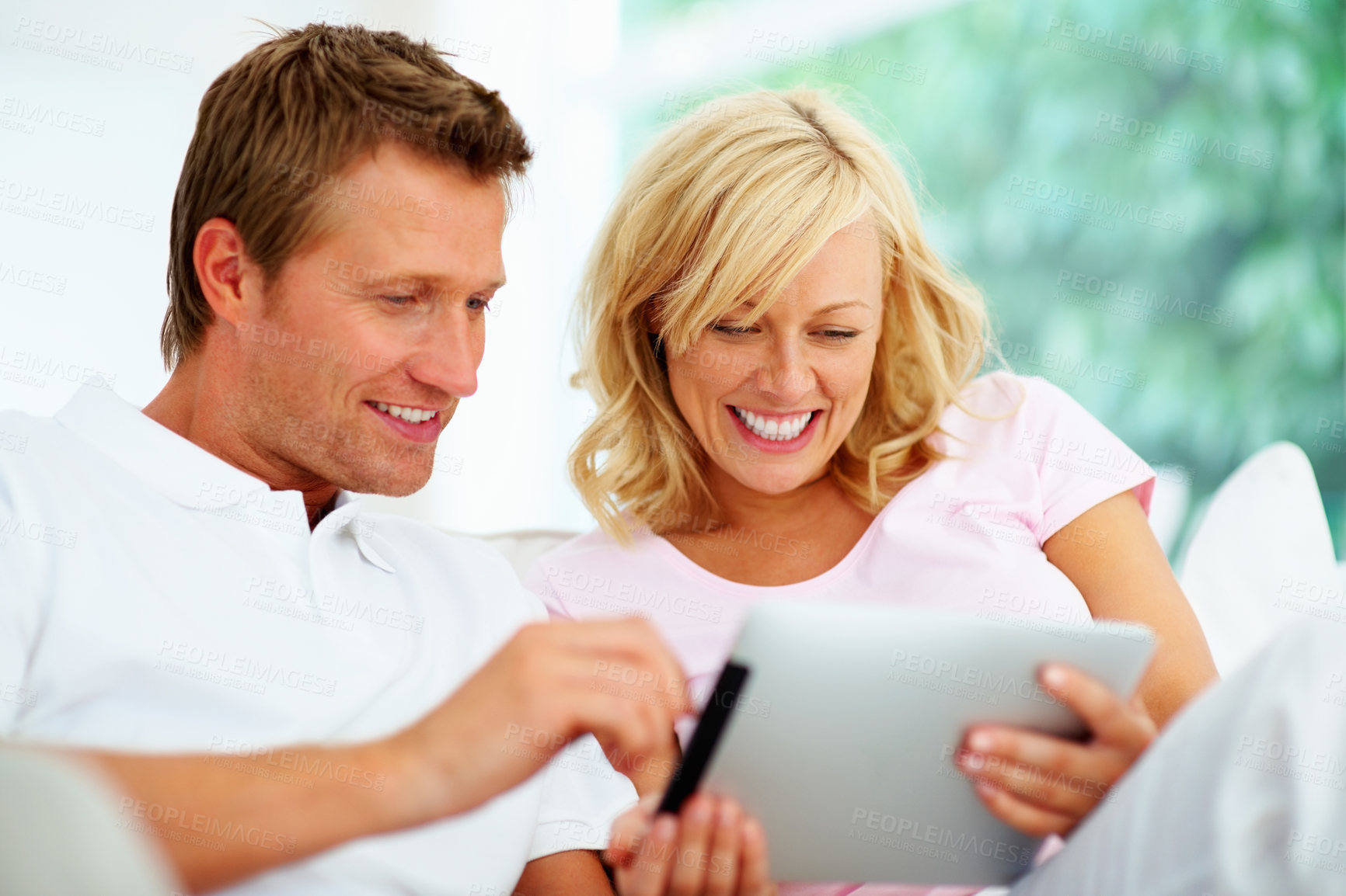 Buy stock photo Couple, tablet and smile in home for social media, download ebook app and streaming internet show. Happy man, woman and scroll on digital technology, online shopping and search blog post in lounge