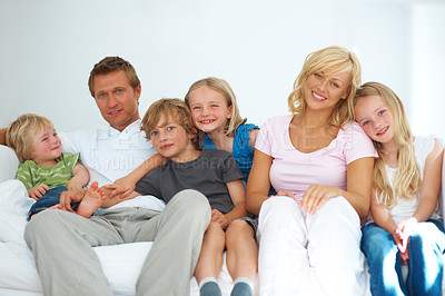 Buy stock photo Mom, dad and portrait with children on sofa for love, care and bonding together in big family home. Happy mother, fathers and kids relaxing on couch for support, growth and development in living room