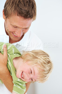 Buy stock photo Happy, fun and father playing with child at home for bonding energy together on a weekend. Smile, positive and young dad being playful with boy kid from Australia for care and love in family house.