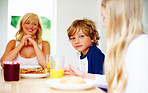 Young little boy with his family having breakfast together