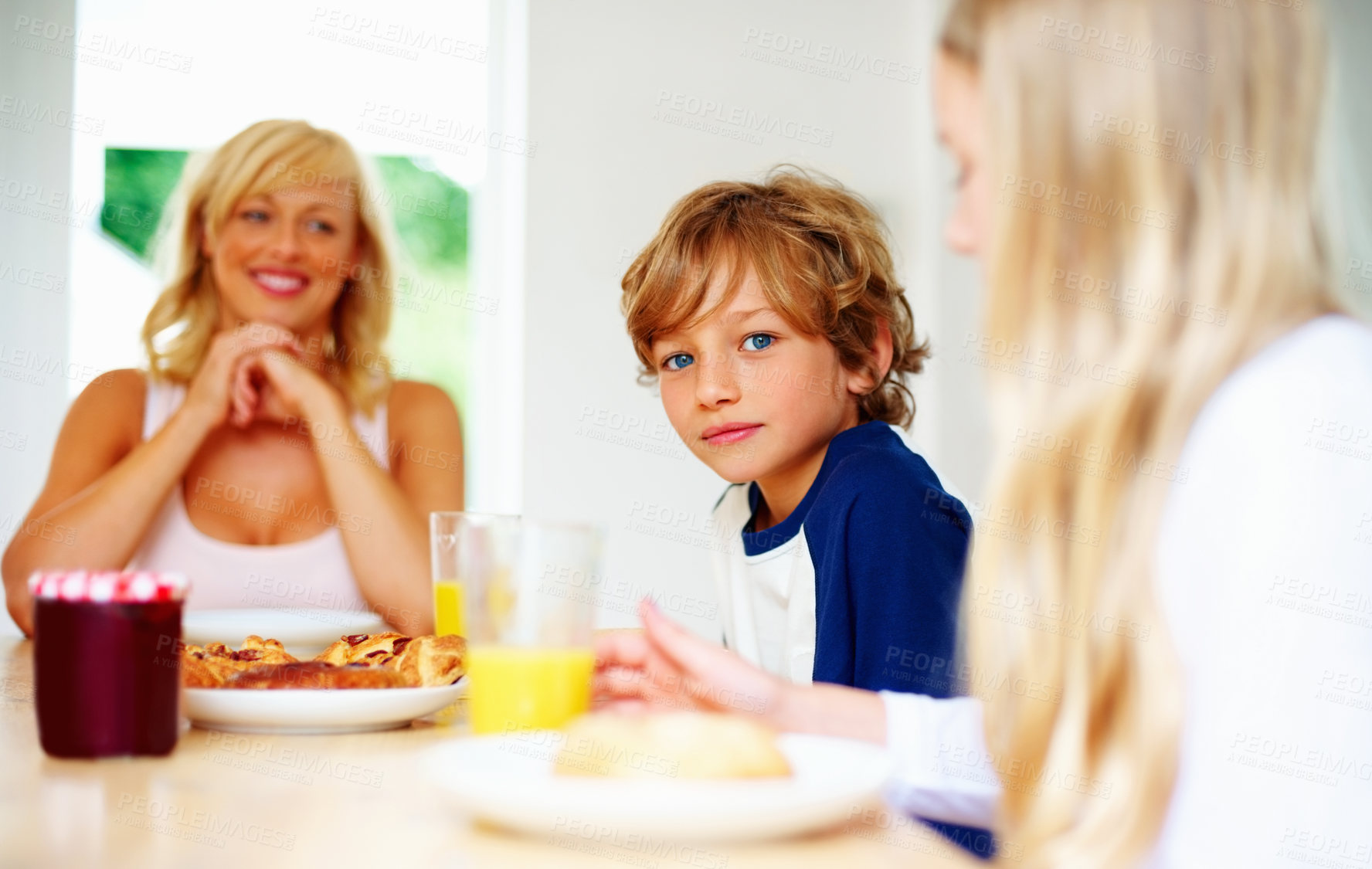 Buy stock photo Happy family, morning and breakfast on weekend, portrait and eating for nutrition, orange juice and meal. Mother, children and enjoying food together for hunger, health and energy for good day