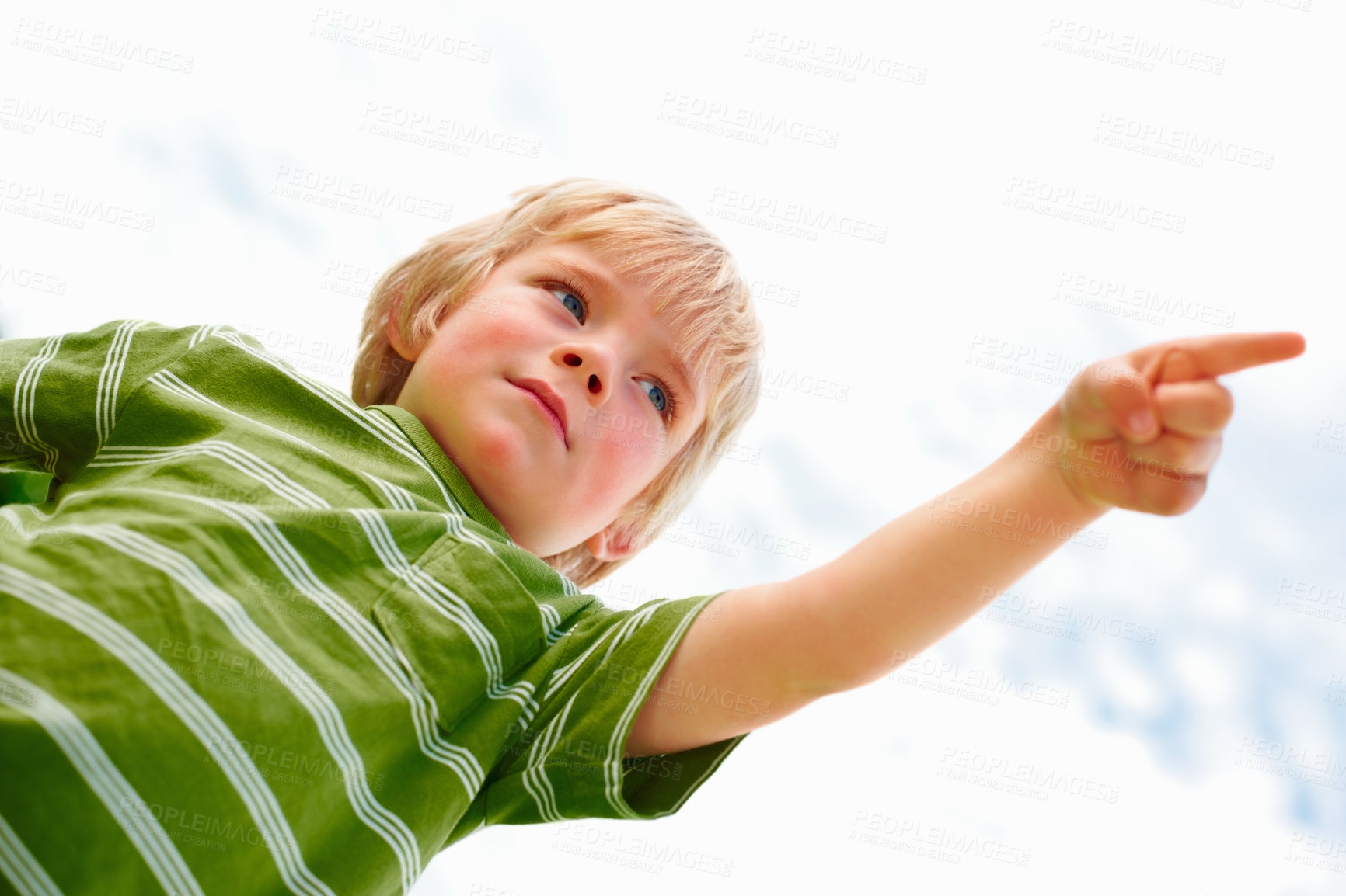 Buy stock photo Children, sky background and a serious boy pointing to blame from below while outdoor on a summer day. Kids, warning and hand gesture with a confident young child in a natural or cloudy environment