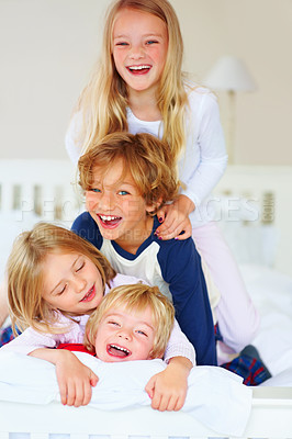 Buy stock photo Portrait, funny or playful with brother and sister sibling kids on a bed in the home together. Family, love or laughing with young boy and girl children in the bedroom of an apartment on the weekend