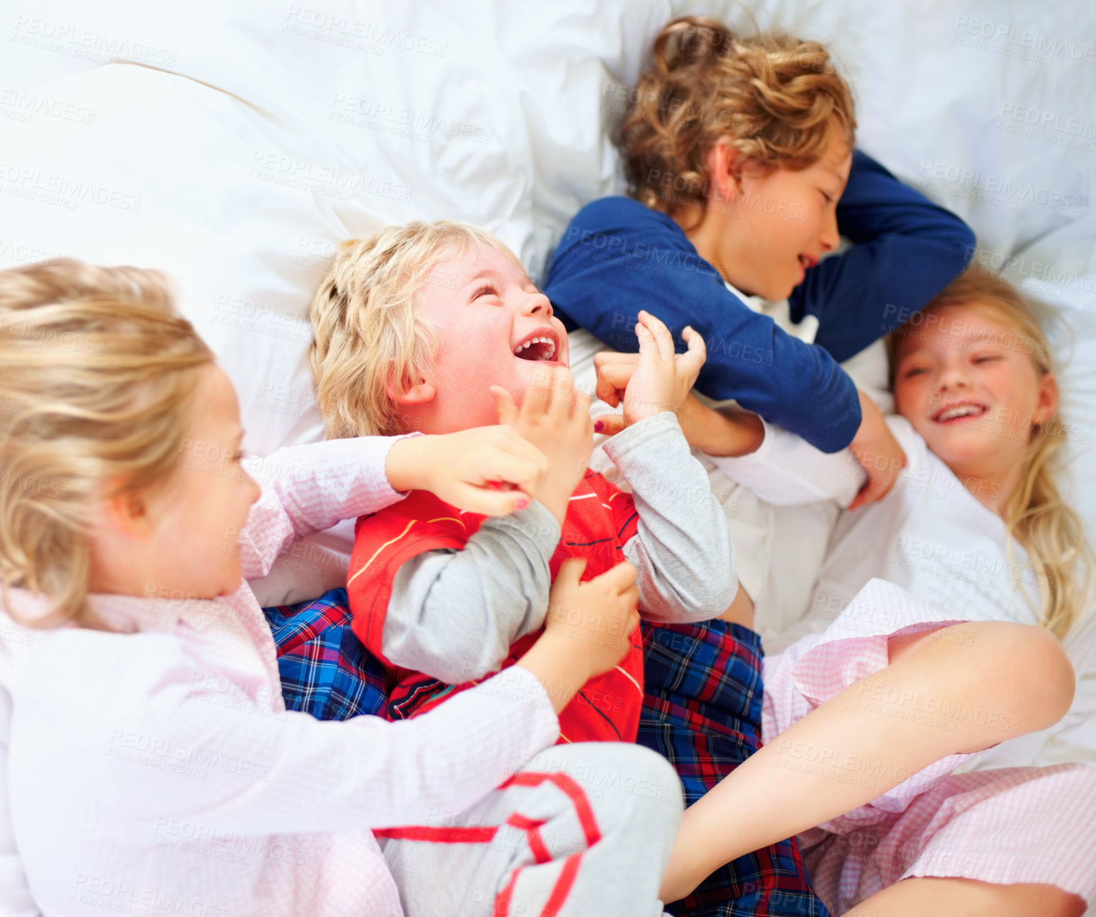 Buy stock photo Laugh, playing and above of children in bedroom for bonding, love and cute relationship. Family, home and top view of brothers, sisters and kids for childhood games, fun and playful on bed together