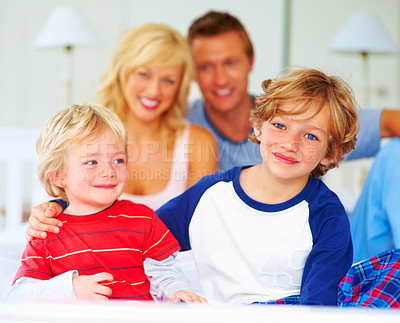 Buy stock photo Happy, portrait and parents with boys on bed for bonding, relaxing and spending time together. Smile, love and young mother and father resting with kids from Australia in bedroom at family home.