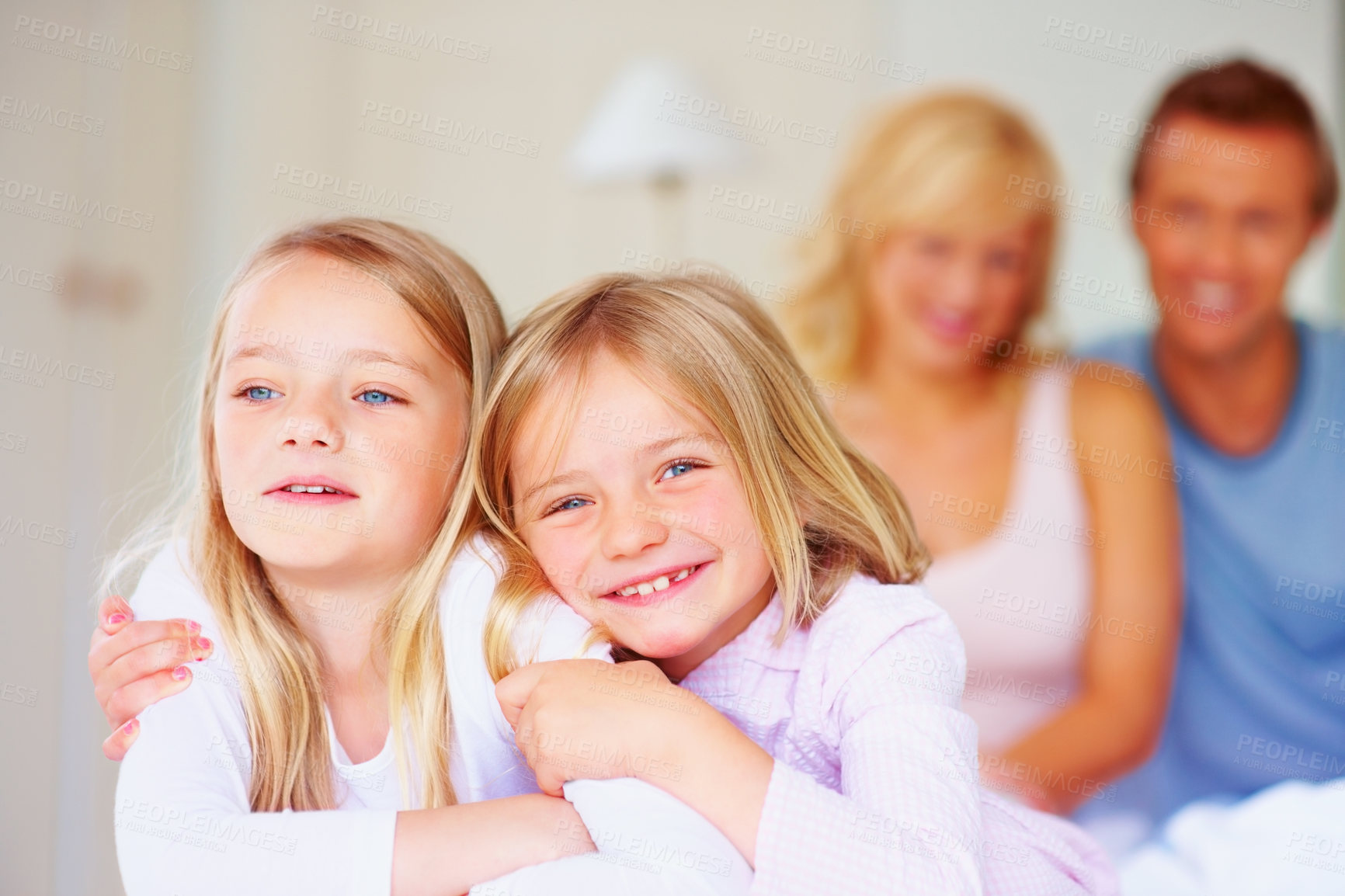 Buy stock photo Portrait, siblings or sisters for hug together on bed, relax wellness and happiness with care support in home. Girls, embrace and smile face for bonding with proud parents and morning love in house