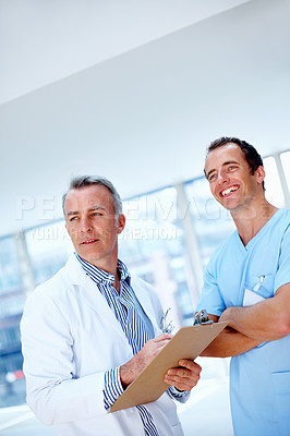 Buy stock photo Doctors, men and clipboard in clinic together for thinking, space or vision for medical results. Medic team, partnership and checklist for wellness, healthcare or idea for problem solving at hospital