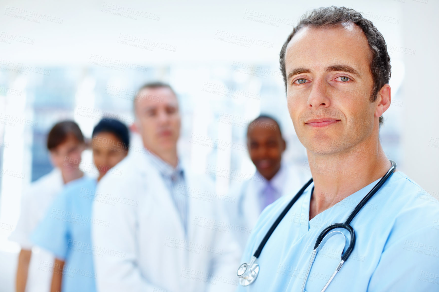 Buy stock photo Doctors, man and group portrait in clinic with staff, leadership or together for healthcare services. Medic, team and solidarity with diversity for inclusion, women or nurses with support in hospital