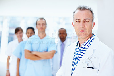 Buy stock photo Doctor, man and portrait of expert with medical, healthcare and clinic staff in a hospital. Teamwork, leadership job and stethoscope of a nurse and surgeon with professional team ready for working