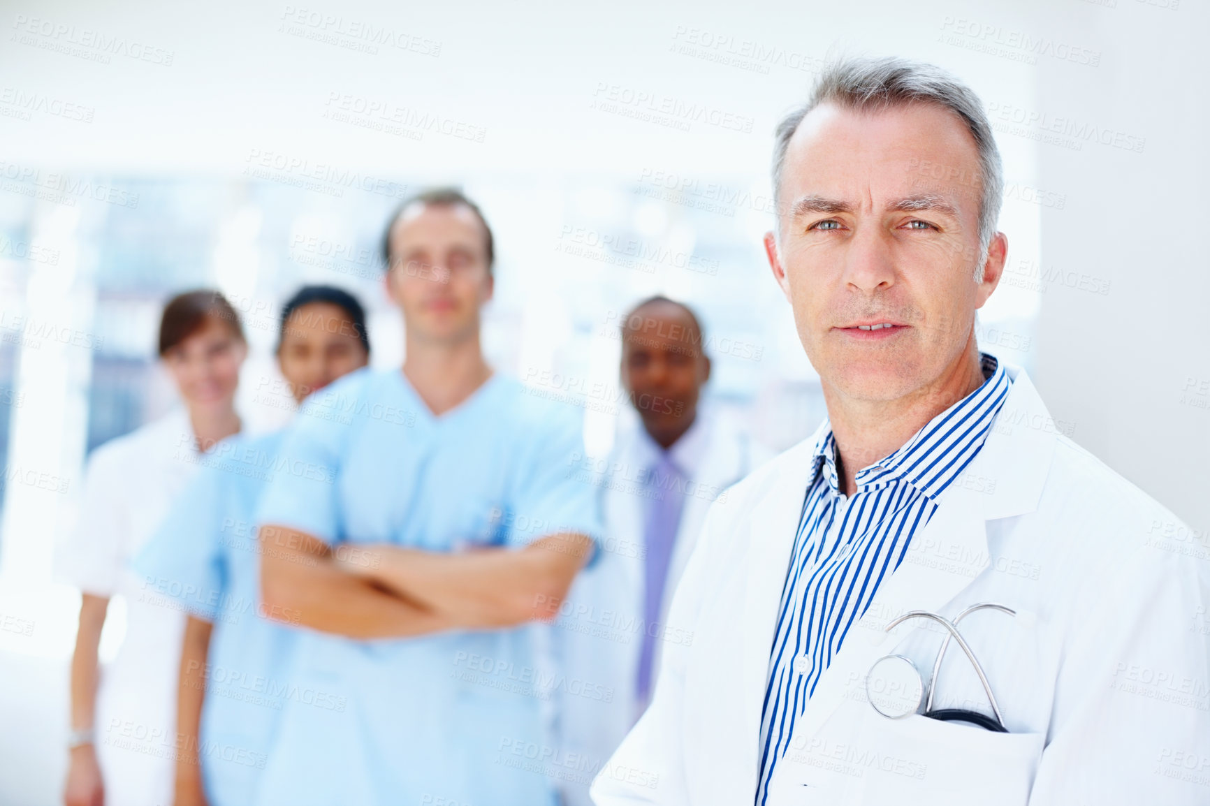 Buy stock photo Doctor, man and portrait of expert with medical, healthcare and clinic staff in a hospital. Teamwork, leadership job and stethoscope of a nurse and surgeon with professional team ready for working