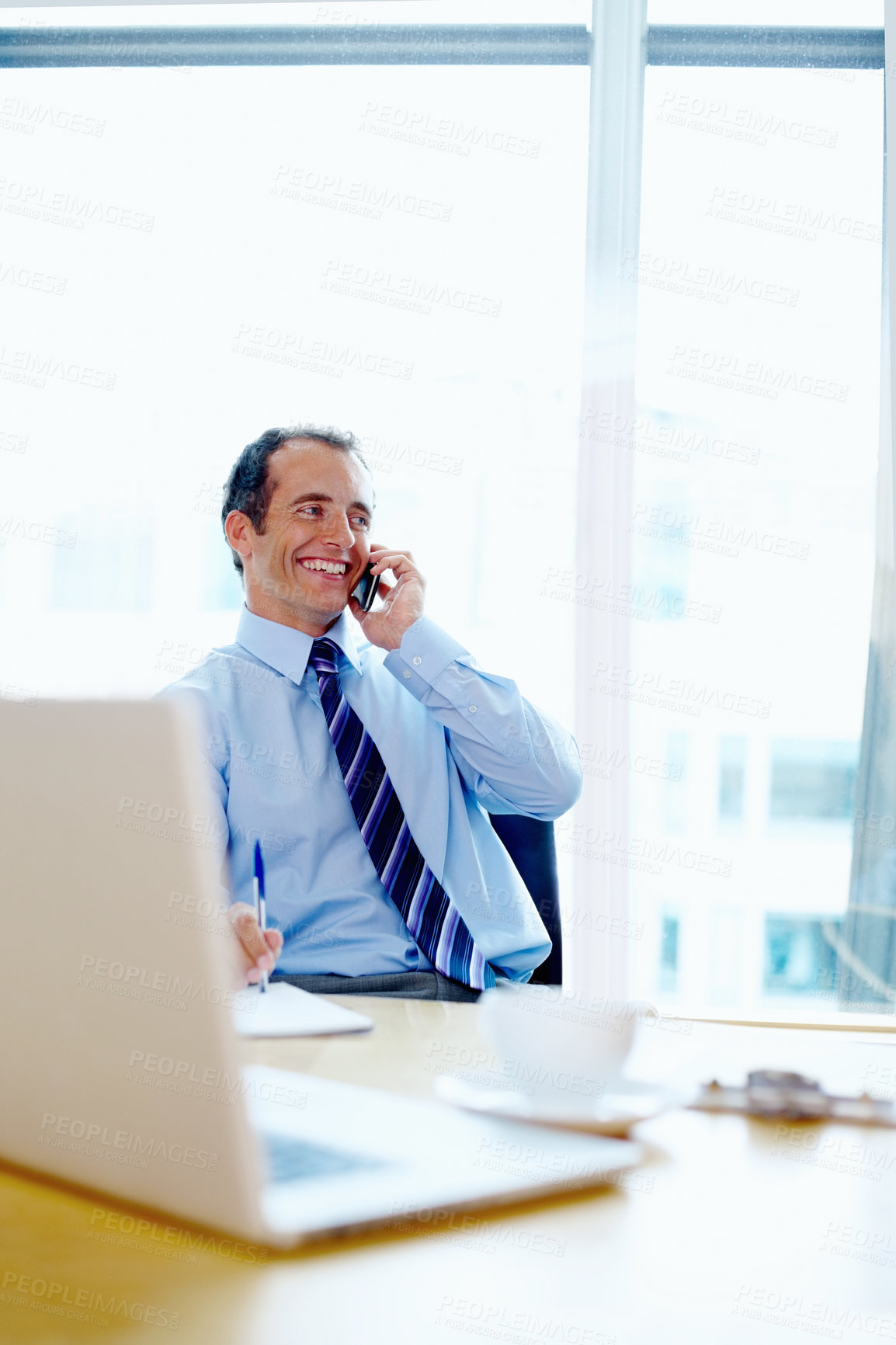 Buy stock photo Businessman, phone call and smile for communication in modern office for discussion. Corporate, male manager and happy with technology for online consultation, listen and idea for financial planning