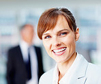 Happy female executive with colleagues in background