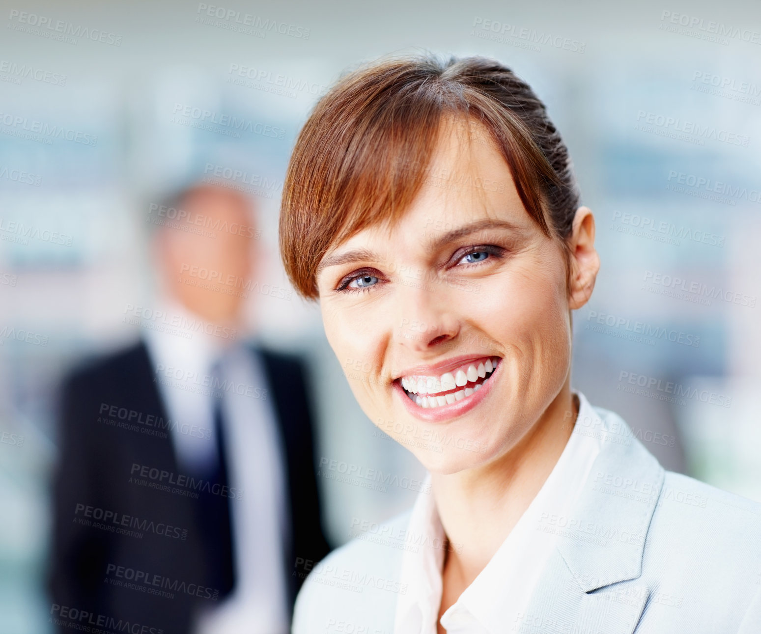 Buy stock photo Focus on happy female executive with team behind her