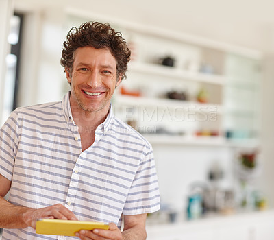 Buy stock photo Portrait of a mature man using a digital tablet at home