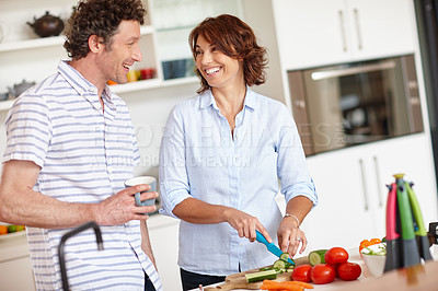 Buy stock photo Shot of a happy mature couple cooking a healthy meal together at home