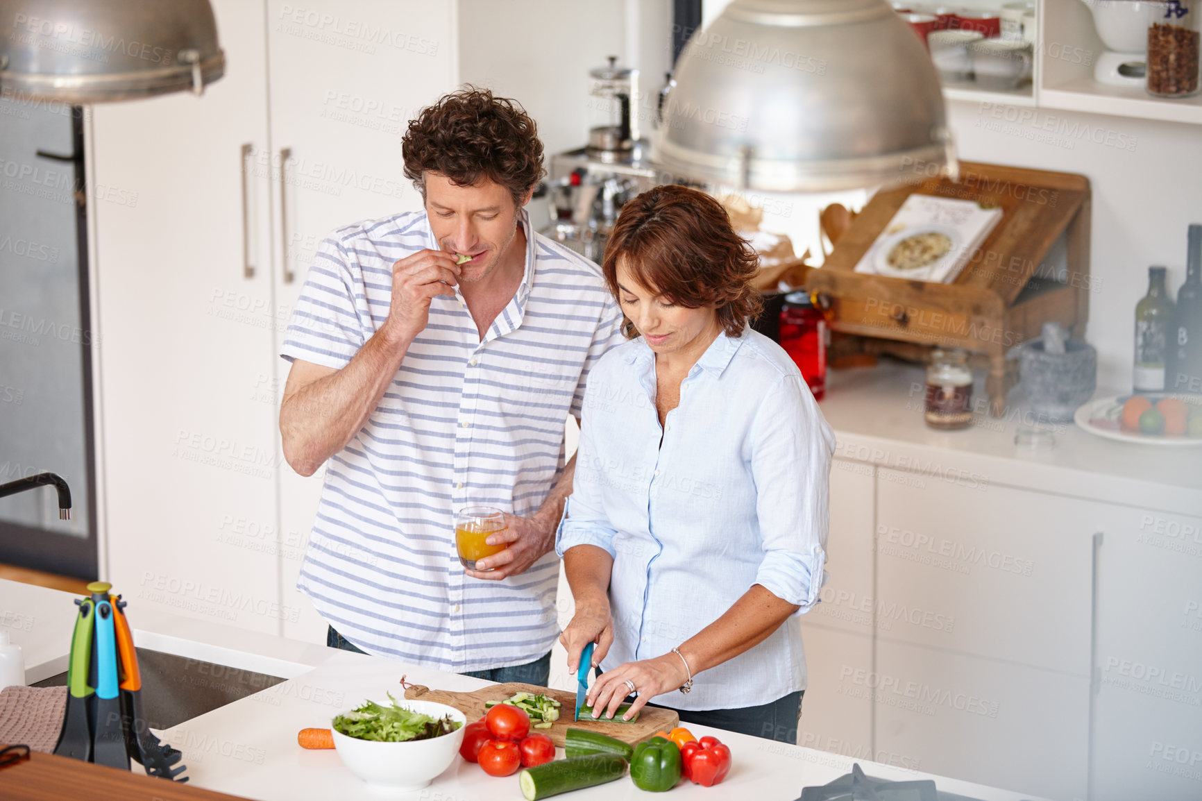 Buy stock photo Shot of a happy mature couple cooking a healthy meal together at home