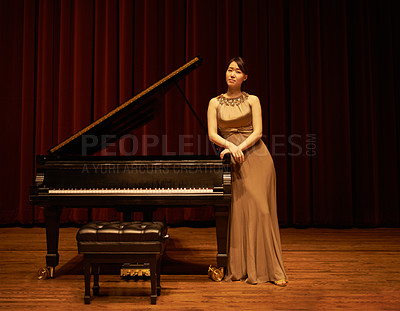 Buy stock photo Piano, theatre and Asian musician for classic music ready for a concert or performance. Portrait, curtain and musical in a grand hall for solo on a stage in Japan with pianist, talent and opera gown