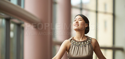 Buy stock photo Shot of an elegantly dressed young woman dancing through a  large hallway