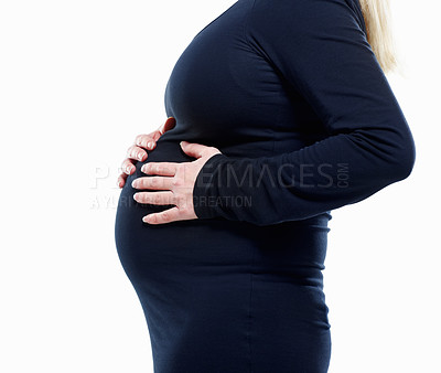 Buy stock photo Mid section of a pregnant woman feeling her baby against white - copyspace
