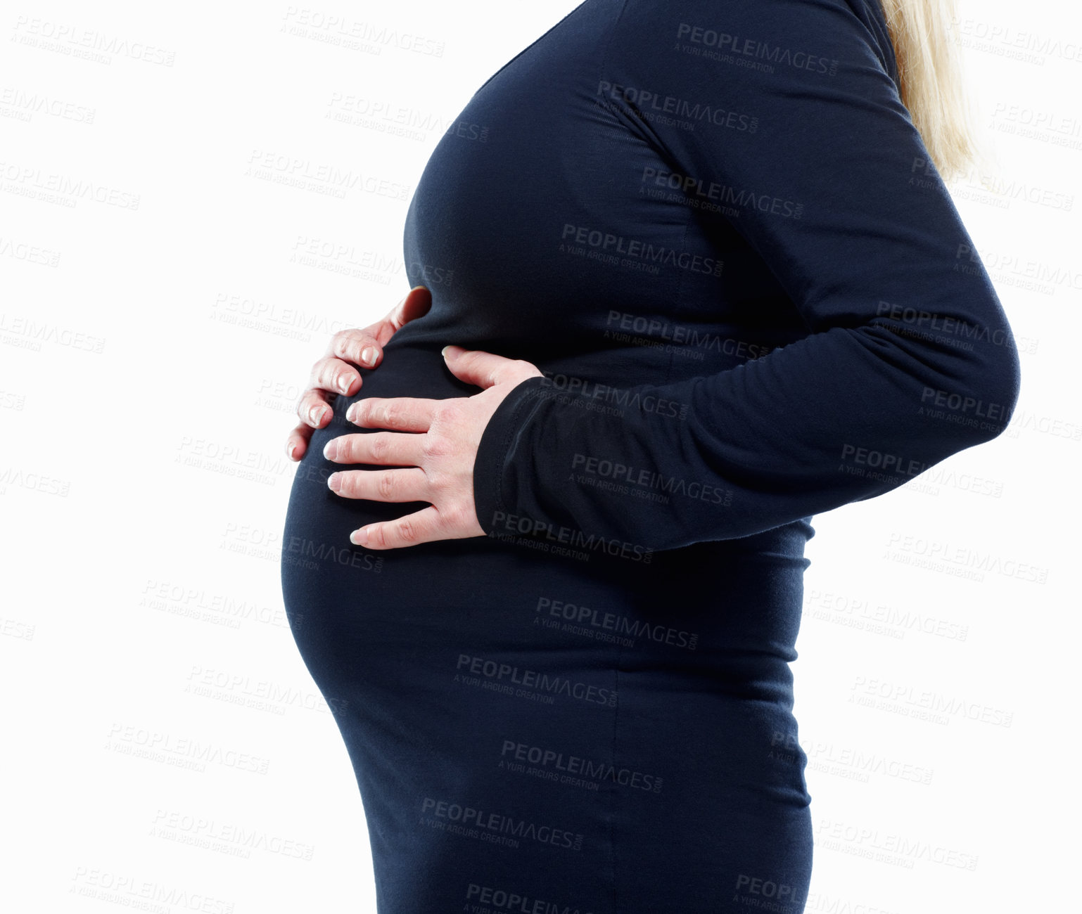 Buy stock photo Mid section of a pregnant woman feeling her baby against white - copyspace