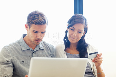 Buy stock photo Beautiful woman holding credit card while home shopping with man