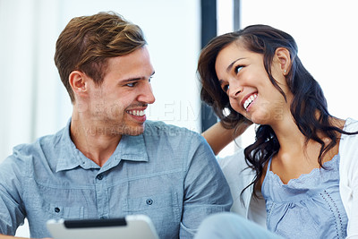 Buy stock photo Closeup of happy young couple relaxing at home using digital tablet