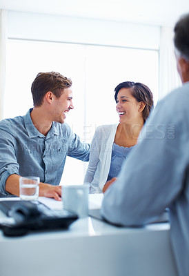 Buy stock photo Portrait of happy couple laughing while discussing with financial advisor