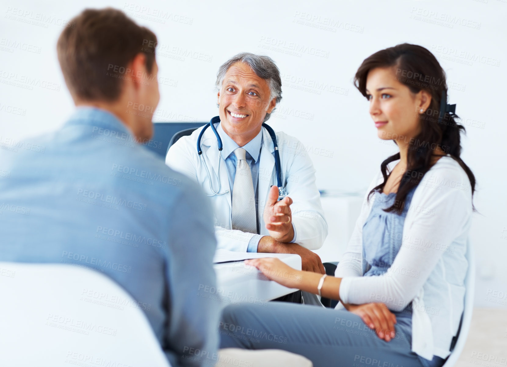 Buy stock photo Couple, doctor and smile as patient at office or clinic for consultation on family planning. People, relationship and gynecologist to explain on good news for feedback, medical and healthcare report