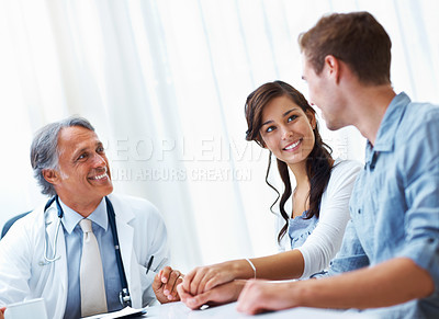 Buy stock photo Portrait of mature doctor and young woman listening to handsome man