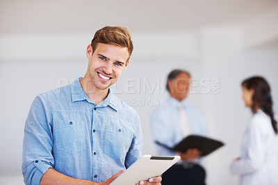 Buy stock photo Portrait of happy business man holding electronic tablet with colleagues in background